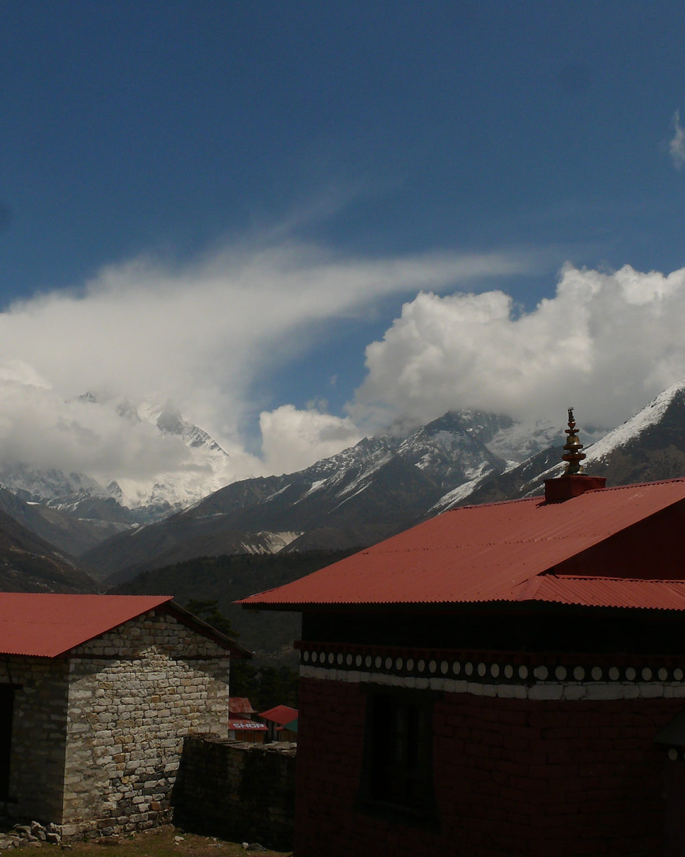 Tengboche monastery, its red roof set against cloud and the peaks of the upper Khumbu.