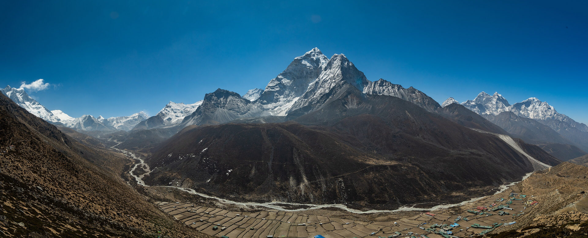The Imja valley above Dingboche at 4,440 metres, the trail running along the valley floor beneath snow-covered peaks.